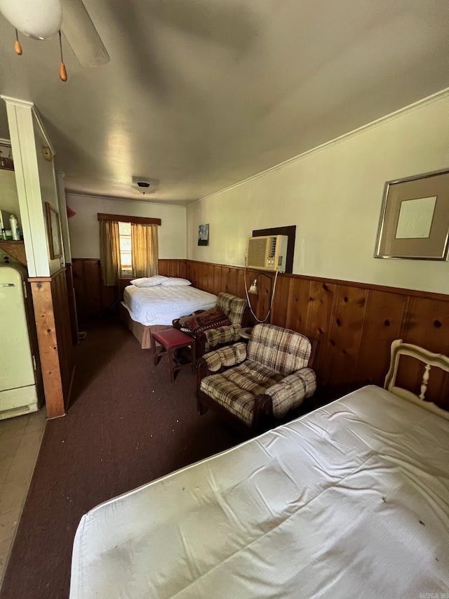 bedroom featuring a wall mounted air conditioner, washer / clothes dryer, ceiling fan, and wood walls