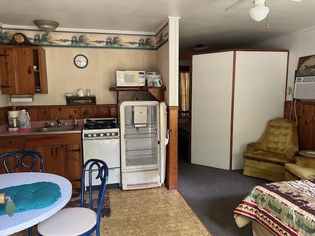 kitchen featuring sink, cooling unit, and white appliances