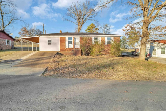 view of front facade with a front yard and a carport