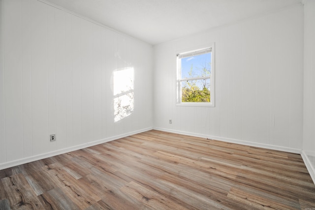 unfurnished room with light hardwood / wood-style floors