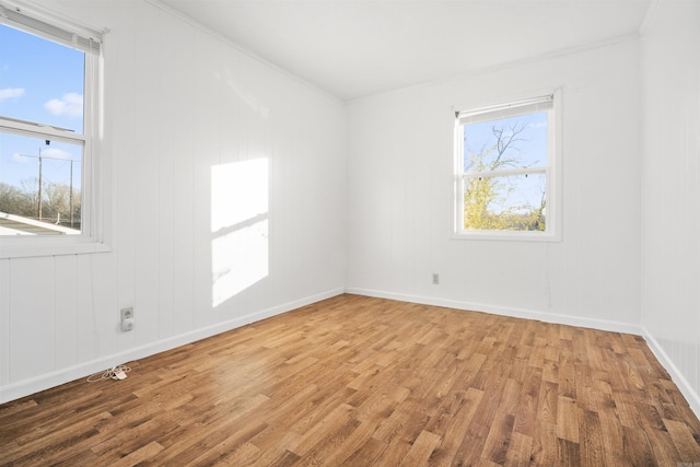 unfurnished room featuring hardwood / wood-style flooring and ornamental molding