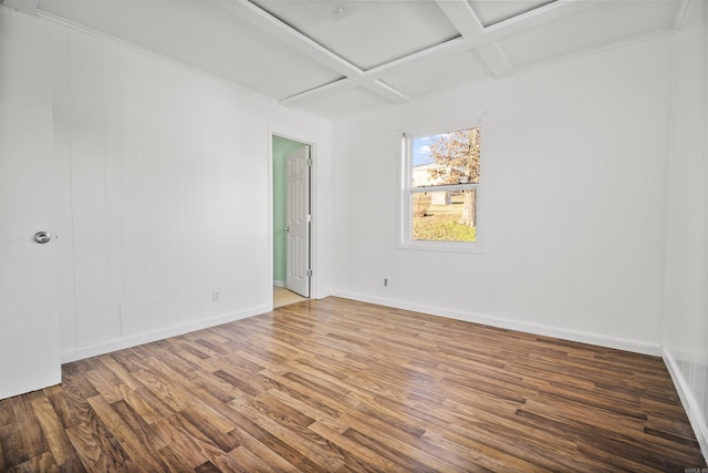 spare room featuring beamed ceiling, hardwood / wood-style floors, and coffered ceiling