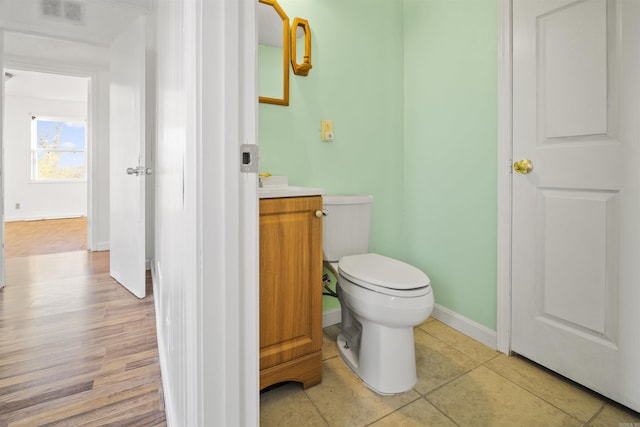 bathroom featuring tile patterned flooring, vanity, and toilet