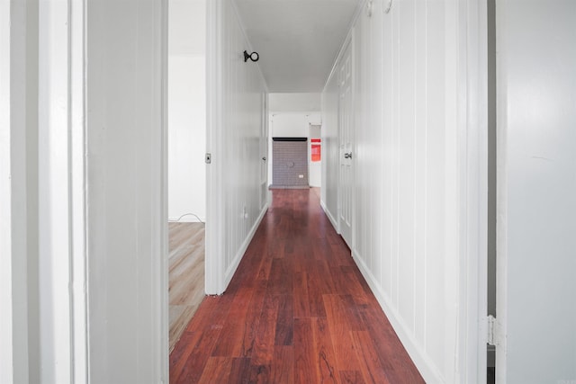 hallway with dark hardwood / wood-style flooring