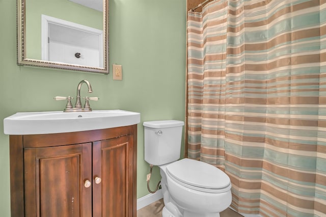 bathroom with vanity, toilet, and walk in shower