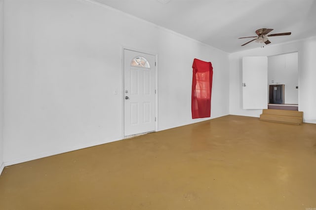 unfurnished living room featuring ceiling fan, concrete flooring, and ornamental molding