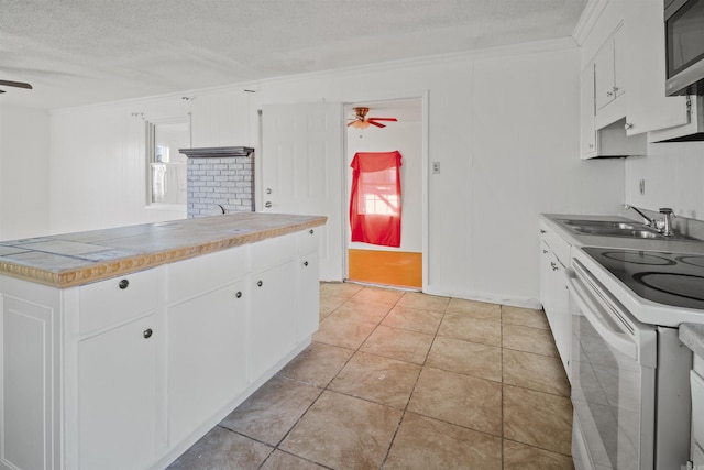 kitchen with white range with electric cooktop, ceiling fan, sink, and white cabinets