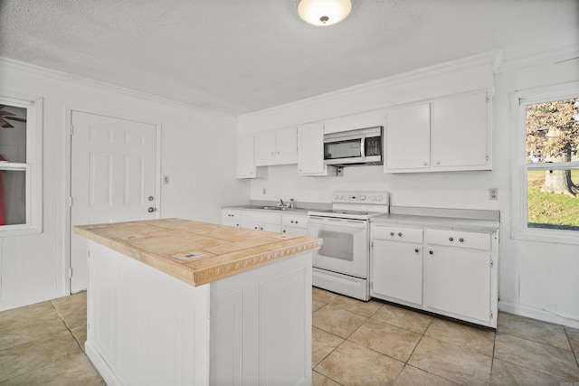 kitchen with white cabinetry, a kitchen island, white electric range, and crown molding