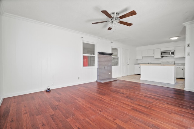 unfurnished living room with light wood-type flooring, ceiling fan, and ornamental molding