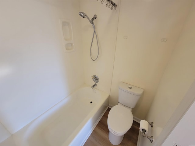 bathroom featuring wood-type flooring, toilet, and shower / washtub combination