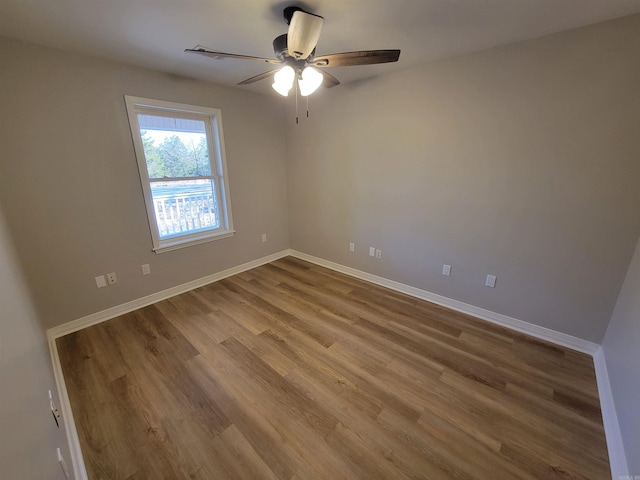 spare room featuring hardwood / wood-style flooring and ceiling fan