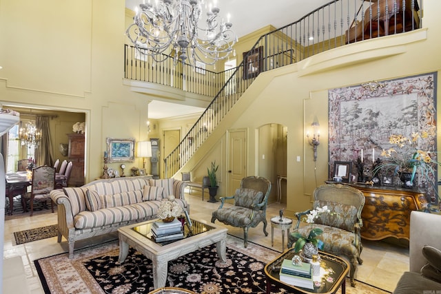 living room with a chandelier and a towering ceiling