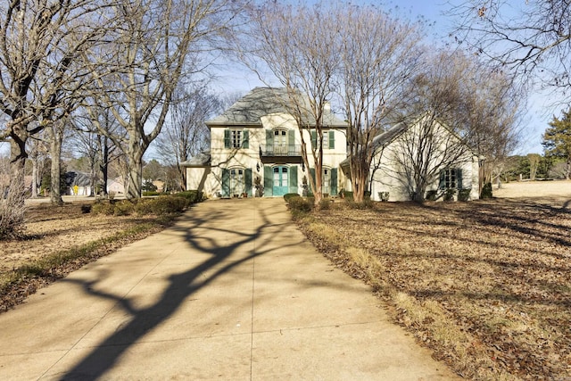 view of front of house featuring a balcony and a garage