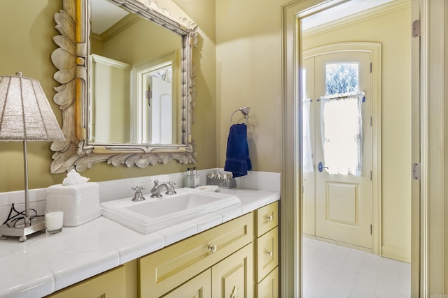 bathroom with vanity and ornamental molding