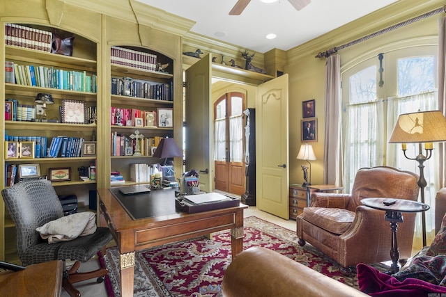 office space with built in shelves, ceiling fan, and crown molding