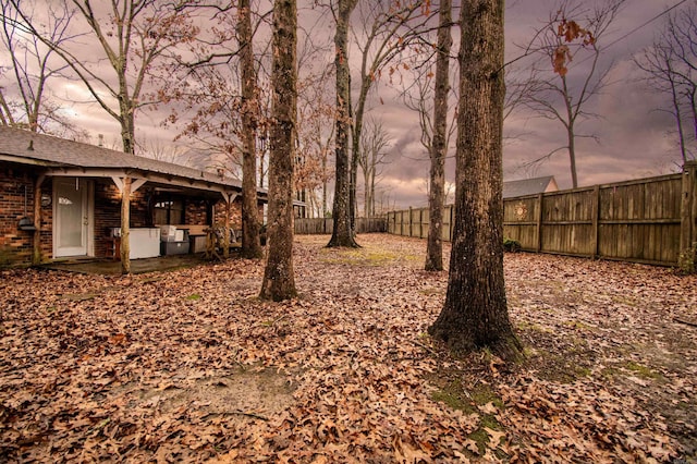 view of yard at dusk