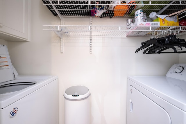 laundry area featuring cabinets and washing machine and dryer