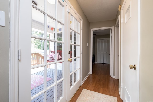 corridor featuring french doors and light wood-type flooring