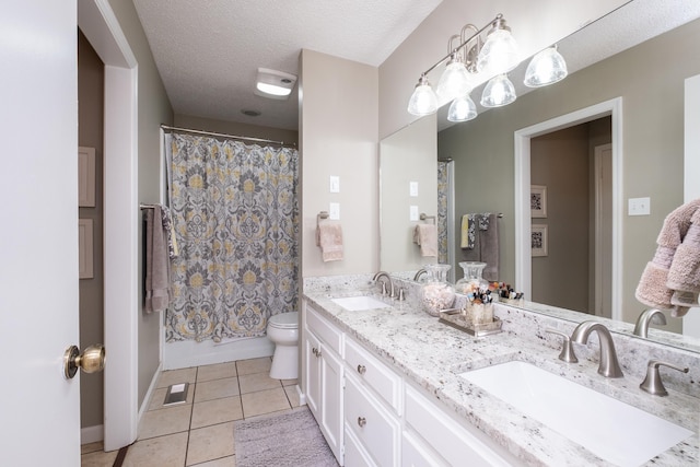 full bathroom with shower / bath combination with curtain, vanity, a textured ceiling, tile patterned flooring, and toilet