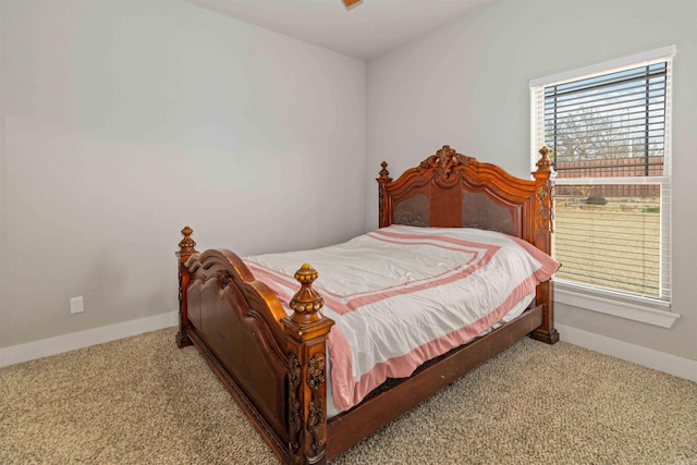 bedroom with multiple windows and light colored carpet