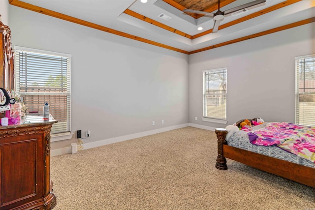 carpeted bedroom featuring a tray ceiling and crown molding