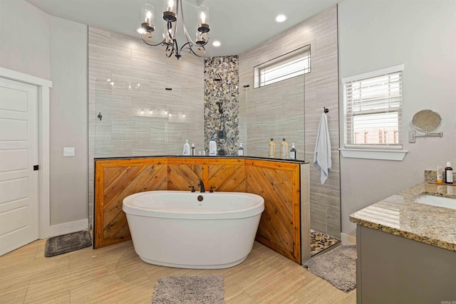 bathroom with a chandelier, vanity, and independent shower and bath