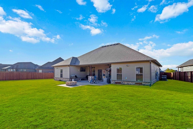 back of property featuring a lawn, ceiling fan, an outdoor fire pit, and a patio