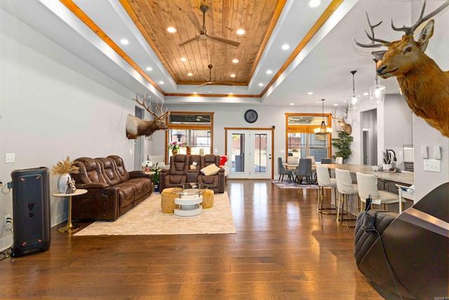 living room with wooden ceiling, french doors, dark hardwood / wood-style floors, ceiling fan, and a tray ceiling