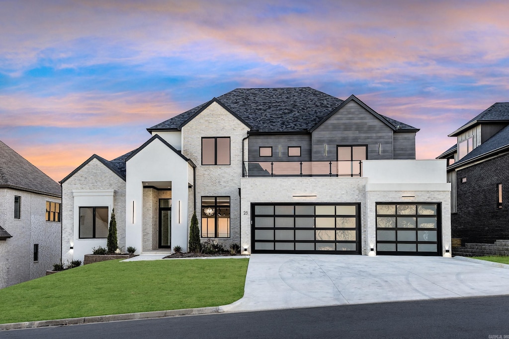 contemporary home with a garage and a yard