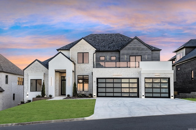 contemporary home with a garage and a yard