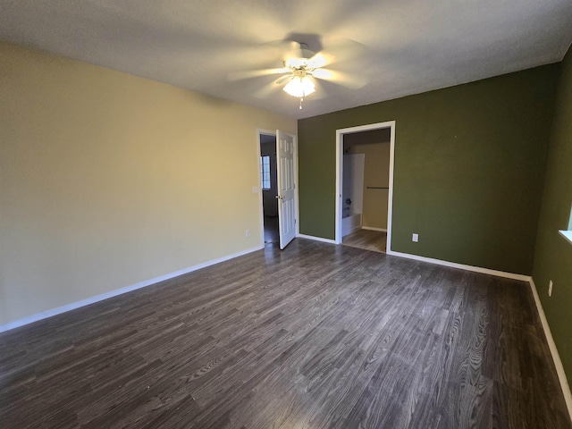 spare room featuring ceiling fan and dark wood-type flooring