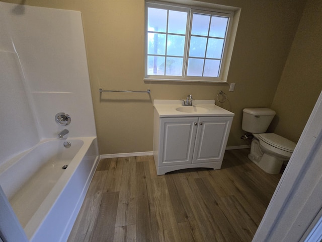 full bathroom featuring vanity, wood-type flooring,  shower combination, and toilet