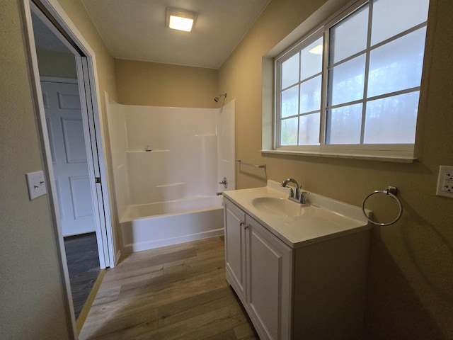 bathroom with shower / washtub combination, vanity, and wood-type flooring