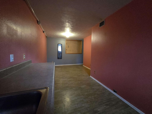 interior space with dark hardwood / wood-style floors and a textured ceiling