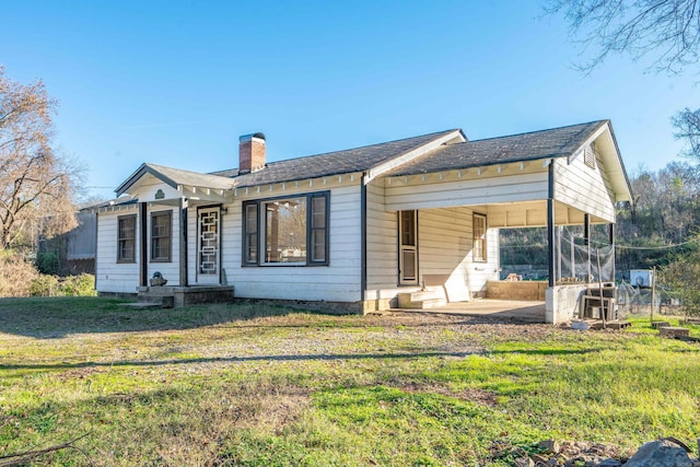 back of house with a lawn