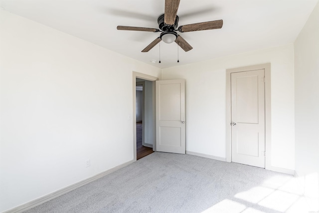 unfurnished bedroom featuring ceiling fan and light carpet