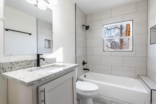 full bathroom with toilet, vanity, and tiled shower / bath