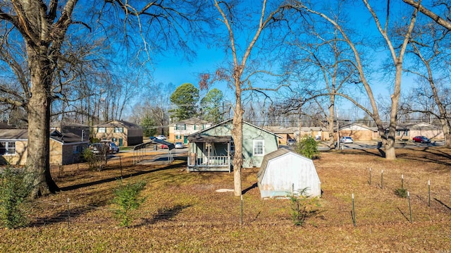 view of yard with a porch and a storage shed