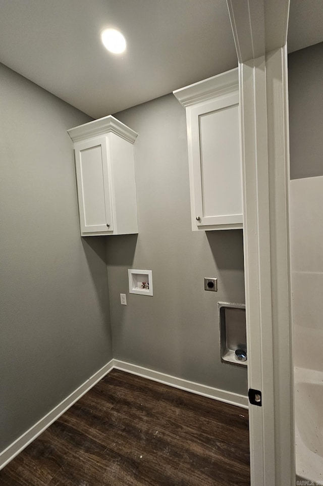 laundry area featuring hookup for a washing machine, cabinets, dark hardwood / wood-style floors, and hookup for an electric dryer