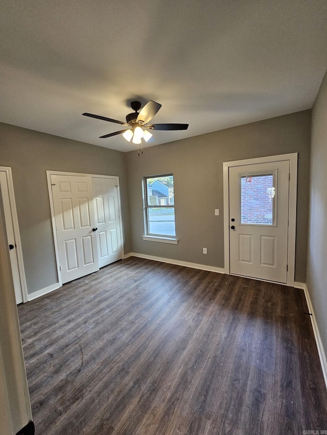 foyer entrance with ceiling fan and dark hardwood / wood-style floors