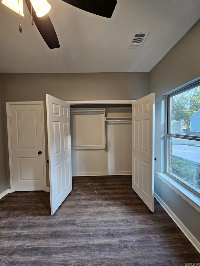 unfurnished bedroom with a closet, ceiling fan, and dark hardwood / wood-style flooring