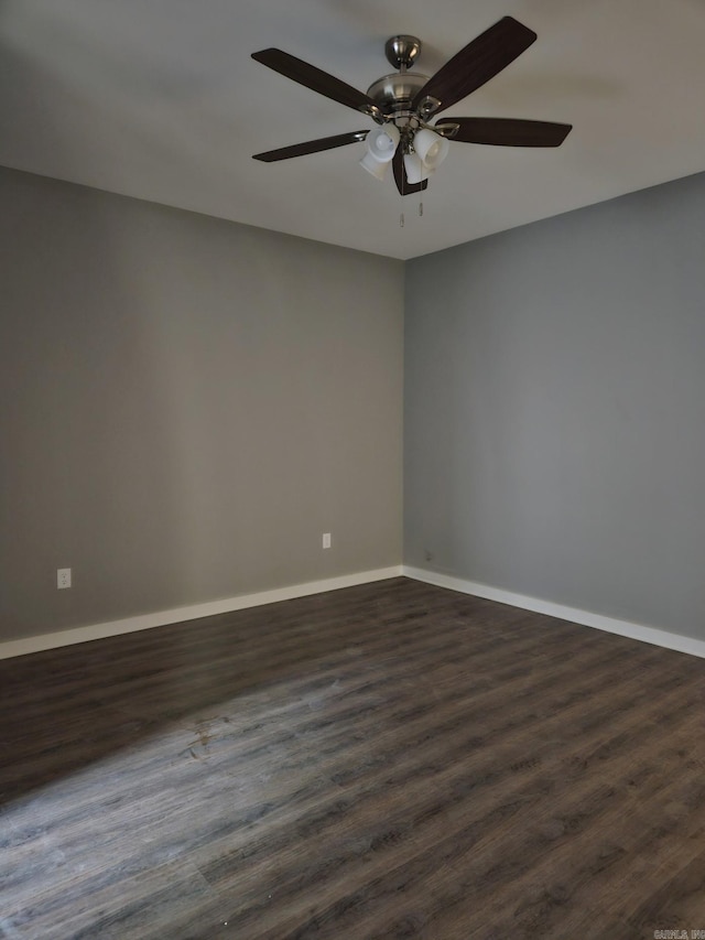 empty room featuring ceiling fan and dark hardwood / wood-style flooring