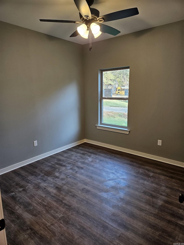 empty room with ceiling fan and dark wood-type flooring