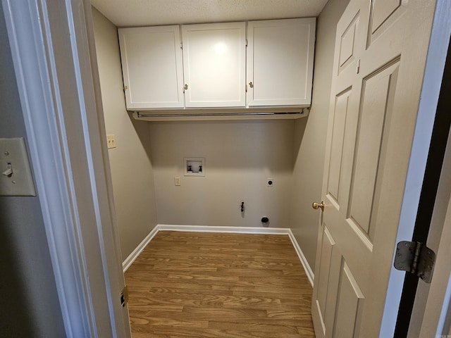 laundry area with cabinets, hookup for a gas dryer, light hardwood / wood-style flooring, washer hookup, and hookup for an electric dryer