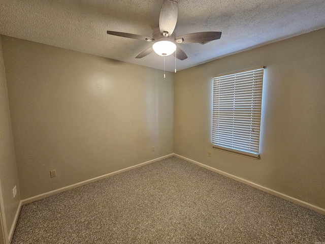 carpeted empty room featuring ceiling fan and a textured ceiling