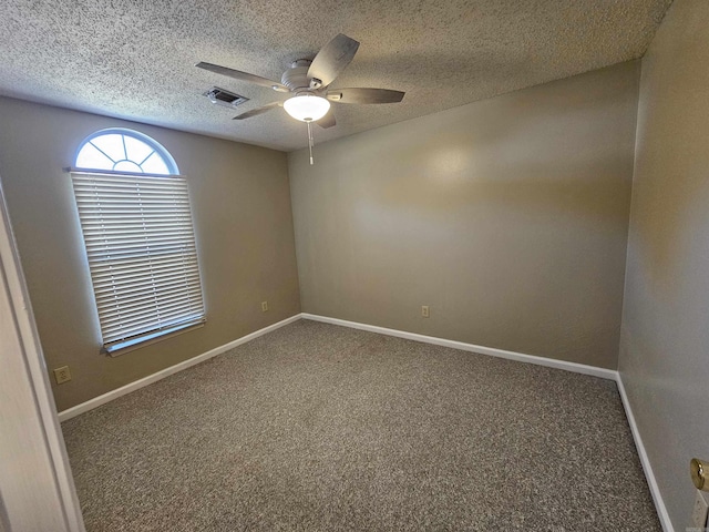 spare room featuring carpet flooring and a textured ceiling