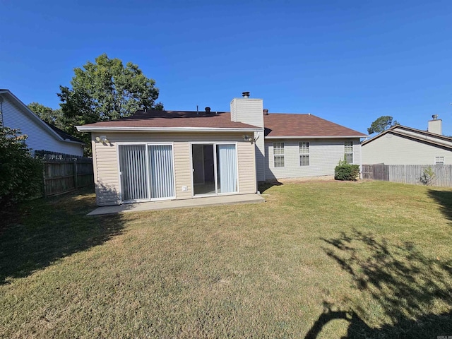 back of house featuring a yard