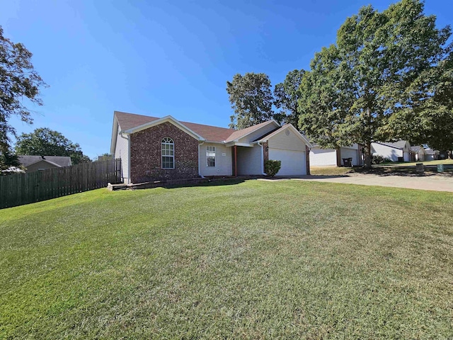 single story home featuring a front yard and a garage