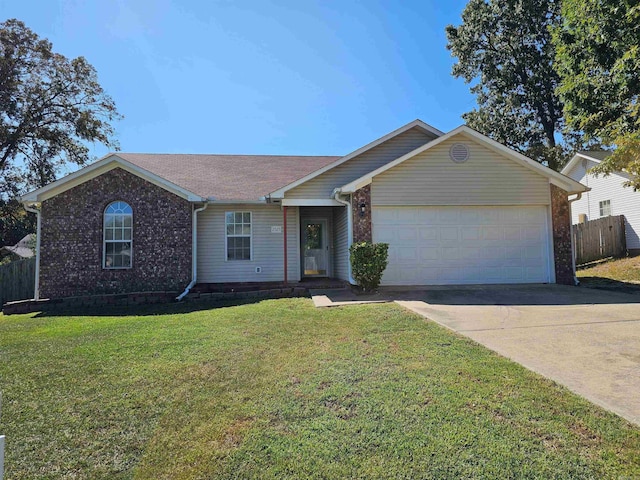 ranch-style home with a garage and a front lawn