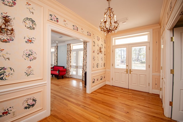 entryway featuring plenty of natural light, light hardwood / wood-style flooring, and french doors